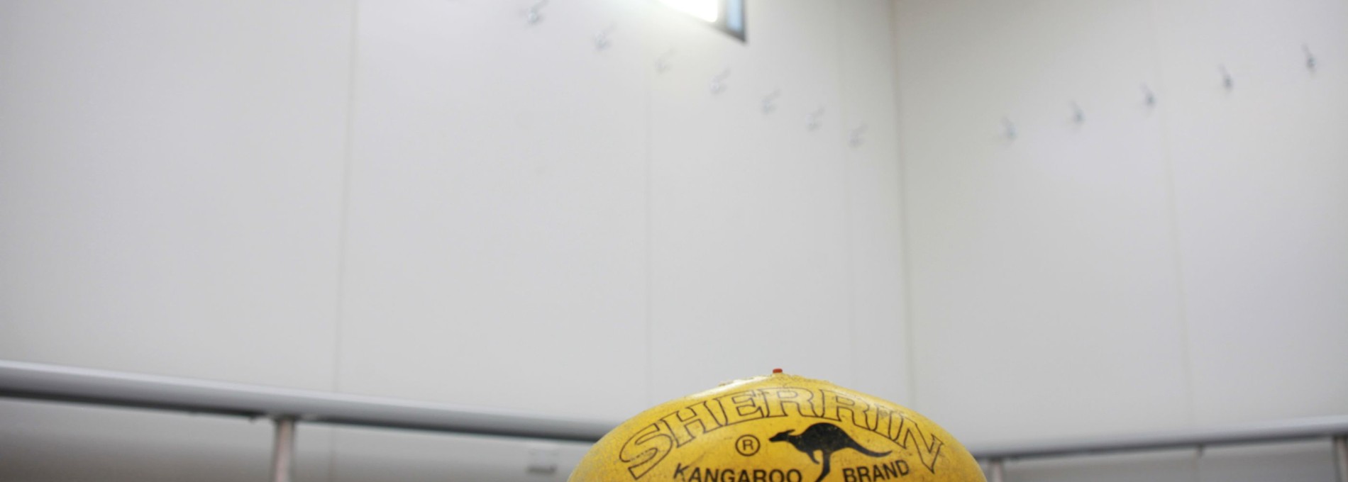 Football on Floor of Sporting Changeroom