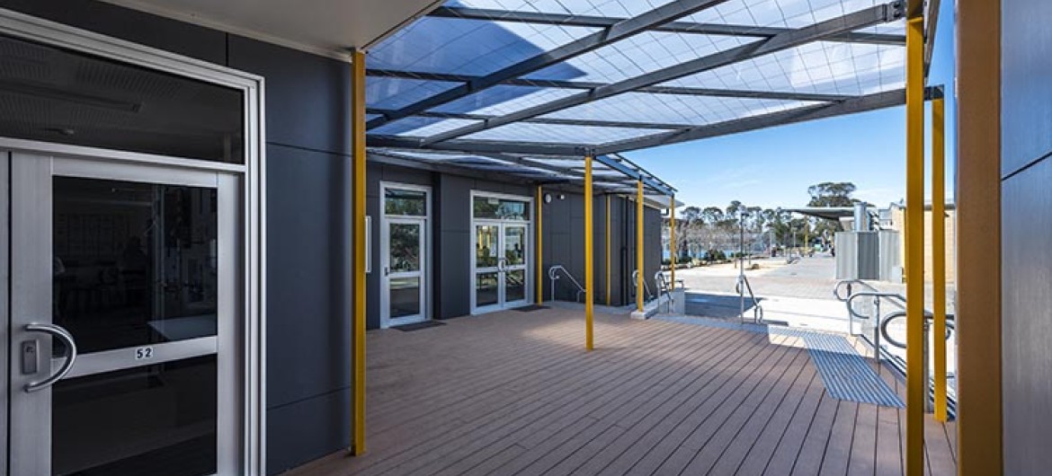 Exterior Classroom Block with Wooden Deck and Glass Roof Shelter