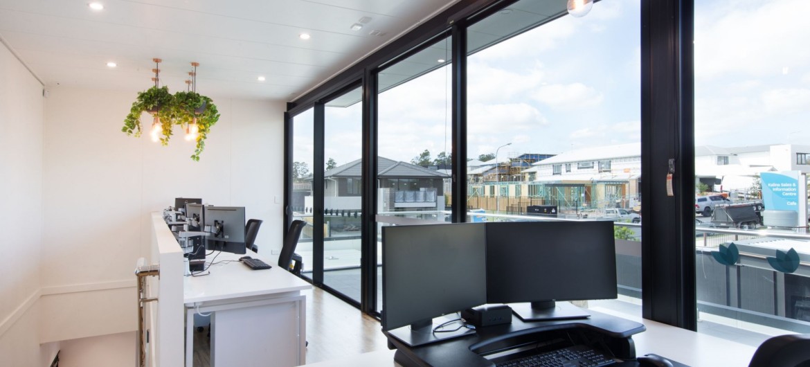 Interior Office with Desks, Computers and Chairs with Glass Doors