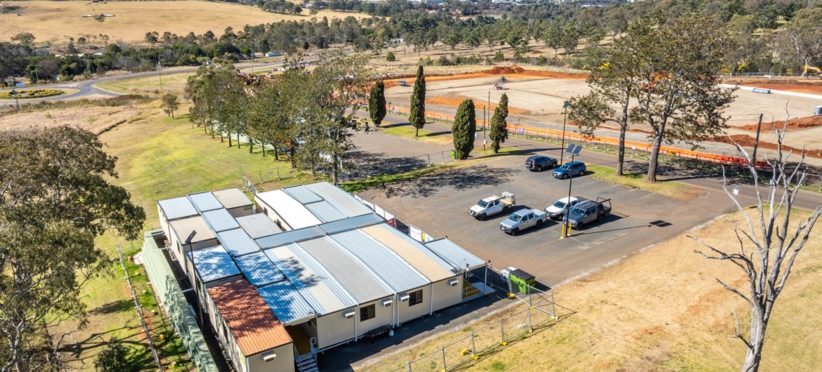 An aerial view of the site compound with empty countryside in the background